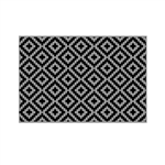Lippert 2024048084 all-weather reversible RV patio mat in black and grey polypropylene, 8 ft x 12 ft, shown laid flat outdoors at campsite.